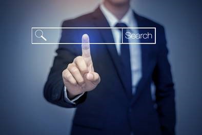 individual in a suite pressing a floating search bar with pointer finger